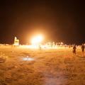 Random fire lighting up the playa at night.