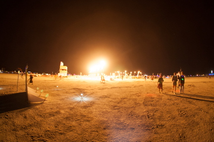 Random fire lighting up the playa at night.
